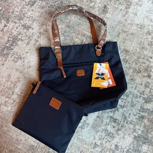 Bric's Sportina Navy Nylon Travel Bag w/ Brown Patch handles and zip pull.